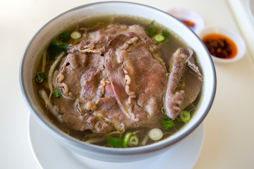 Vietnamese beef pho noodle soup on the white table