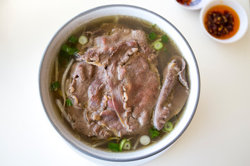 Vietnamese beef pho noodle soup on the white table