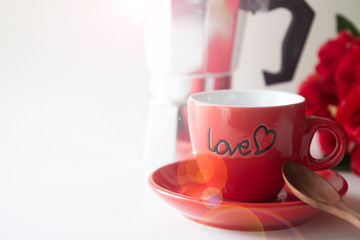 Close up red coffee cup on white background with red rose and coffee pot