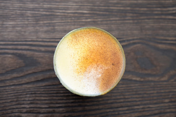 Gold-coloured turmeric latte in the cup