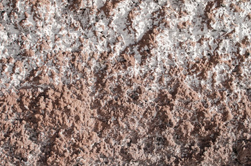 embossed brown wall with white splashes in side lighting