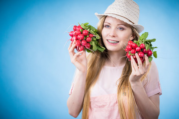 Young woman holding radish