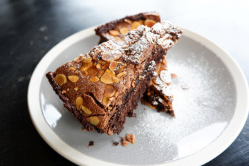 brownies cake on the table / piece of chocolate cake cocoa with nut and icing sugar