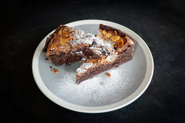 brownies cake on the table / piece of chocolate cake cocoa with nut and icing sugar