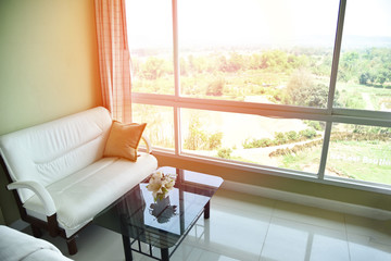 sofa in the morning room sunlight through open window / bedroom and white sofa pillow