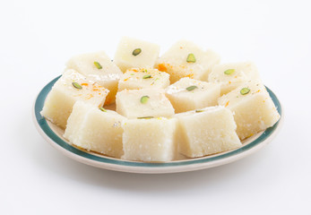 Indian Popular Sweet Food Khopara Pak or Coconut Burfi made up of Coconut, Milk And Sugar Isolated on White Background
