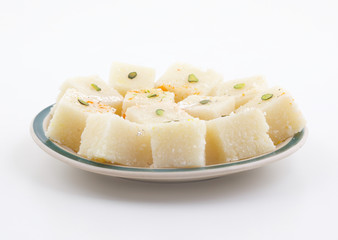 Indian Popular Sweet Food Khopara Pak or Coconut Burfi made up of Coconut, Milk And Sugar Isolated on White Background