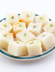 Indian Popular Sweet Food Khopara Pak or Coconut Burfi made up of Coconut, Milk And Sugar Isolated on White Background