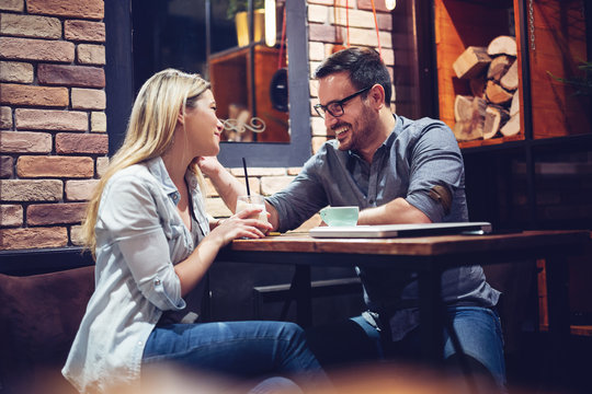 Young attractive couple flirting in cafe.