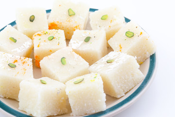 Indian Popular Sweet Food Khopara Pak or Coconut Burfi made up of Coconut, Milk And Sugar Isolated on White Background