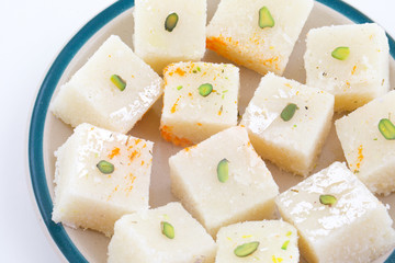 Indian Popular Sweet Food Khopara Pak or Coconut Burfi made up of Coconut, Milk And Sugar Isolated on White Background