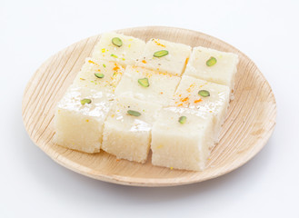 Indian Popular Sweet Food Khopara Pak or Coconut Burfi made up of Coconut, Milk And Sugar Isolated on White Background