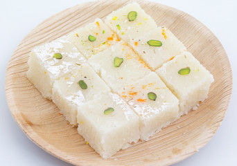 Indian Popular Sweet Food Khopara Pak or Coconut Burfi made up of Coconut, Milk And Sugar Isolated on White Background