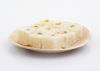 Indian Popular Sweet Food Khopara Pak or Coconut Burfi made up of Coconut, Milk And Sugar Isolated on White Background