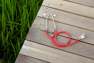 stethoscope red on wood outdoor