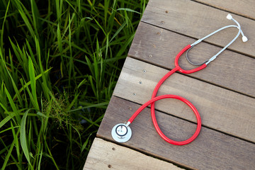stethoscope red on wood outdoor