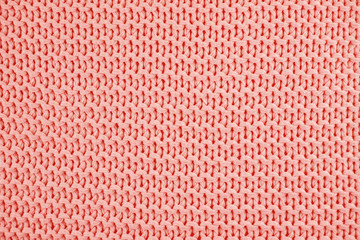 Knitted texture in Coral color. Close up.