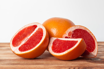 Naklejka na ściany i meble Grapefruit with slices on a wooden table.