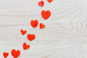 Plenty of cut out paper red hearts on wooden backround, perspective,  selective focus