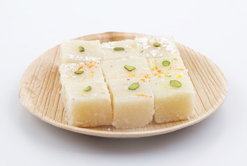 Indian Popular Sweet Food Khopara Pak or Coconut Burfi made up of Coconut, Milk And Sugar Isolated on White Background
