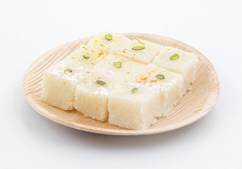 Indian Popular Sweet Food Khopara Pak or Coconut Burfi made up of Coconut, Milk And Sugar Isolated on White Background