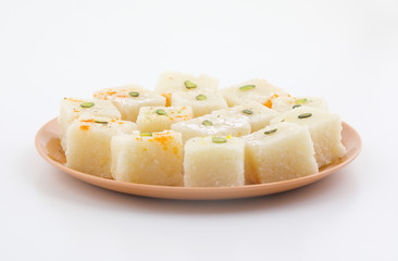 Indian Popular Sweet Food Khopara Pak or Coconut Burfi made up of Coconut, Milk And Sugar Isolated on White Background