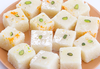 Indian Popular Sweet Food Khopara Pak or Coconut Burfi made up of Coconut, Milk And Sugar Isolated on White Background