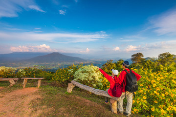 The lovers  in red jacket touring on the beautiful mountain.