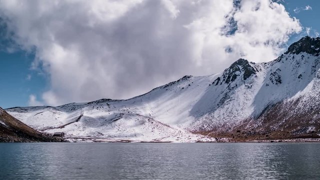 4k Timelapse video of the nevado de toluca volcano after a snowfall with a view of the main lagoon called laguna de la luna in a side slide motion