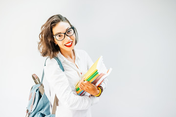 Portrait of a happy girl student or young teacher with backpack and books in university campus © EdNurg