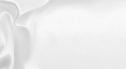 Smooth elegant white silk or satin luxury cloth texture as wedding background. Luxurious Christmas background or New Year background design
