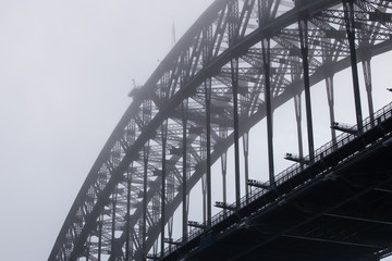 Close-up view of Sydney Harbour Bridge in a foggy morning.