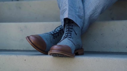 Close up of grooms shoes sitting on steps at his wedding