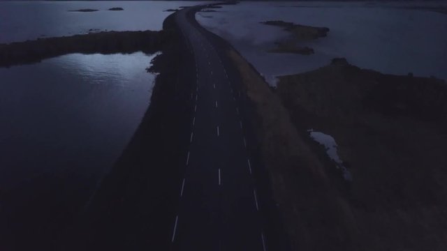 Drone shot in the Westfjords of Iceland flying along a street into the Landscape