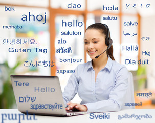 translation, business and technology concept - smiling female translator or operator with computer...