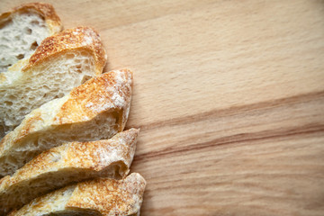 Sliced bread on a wooden table.