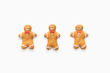 Three happy smiling gingerbread men on white background