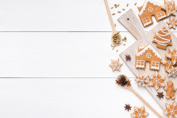 Christmas gingerbread cookies, spices on white wood