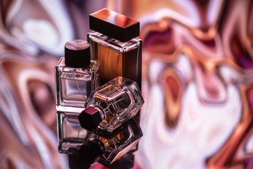 Three colognes on an abstract background