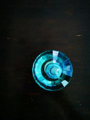Perfume bottle in turquoise colour and gemstone design.