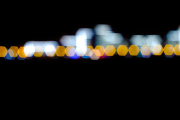 Color bokeh circles on a dark background, abstraction, background. Defocused blur across