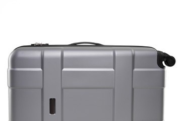 Fragment of gray plastic valise on wheels isolated on white background