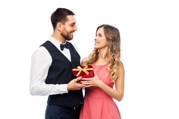 valentines day and people concept - happy couple with gist box in shape of heart