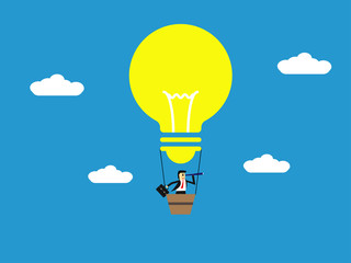 businessman with binoculars on Light bulb balloon flying in the sky,stong idea,business concept