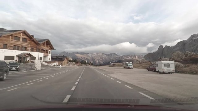 POV driving through Passo Pordoi in the Dolomites, Italy.