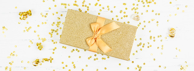 Golden gift box with confetti