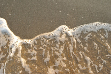 summer sea, foam of undertow on a beach