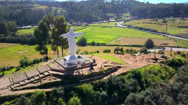 Beautiful Aerial reveal shot of White Christ and latin city of Cusco.