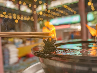 Close up burning joss stick in Temple