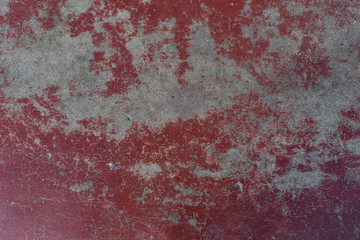Peeling paint on cement wall texture. Pattern of rustic red grunge.